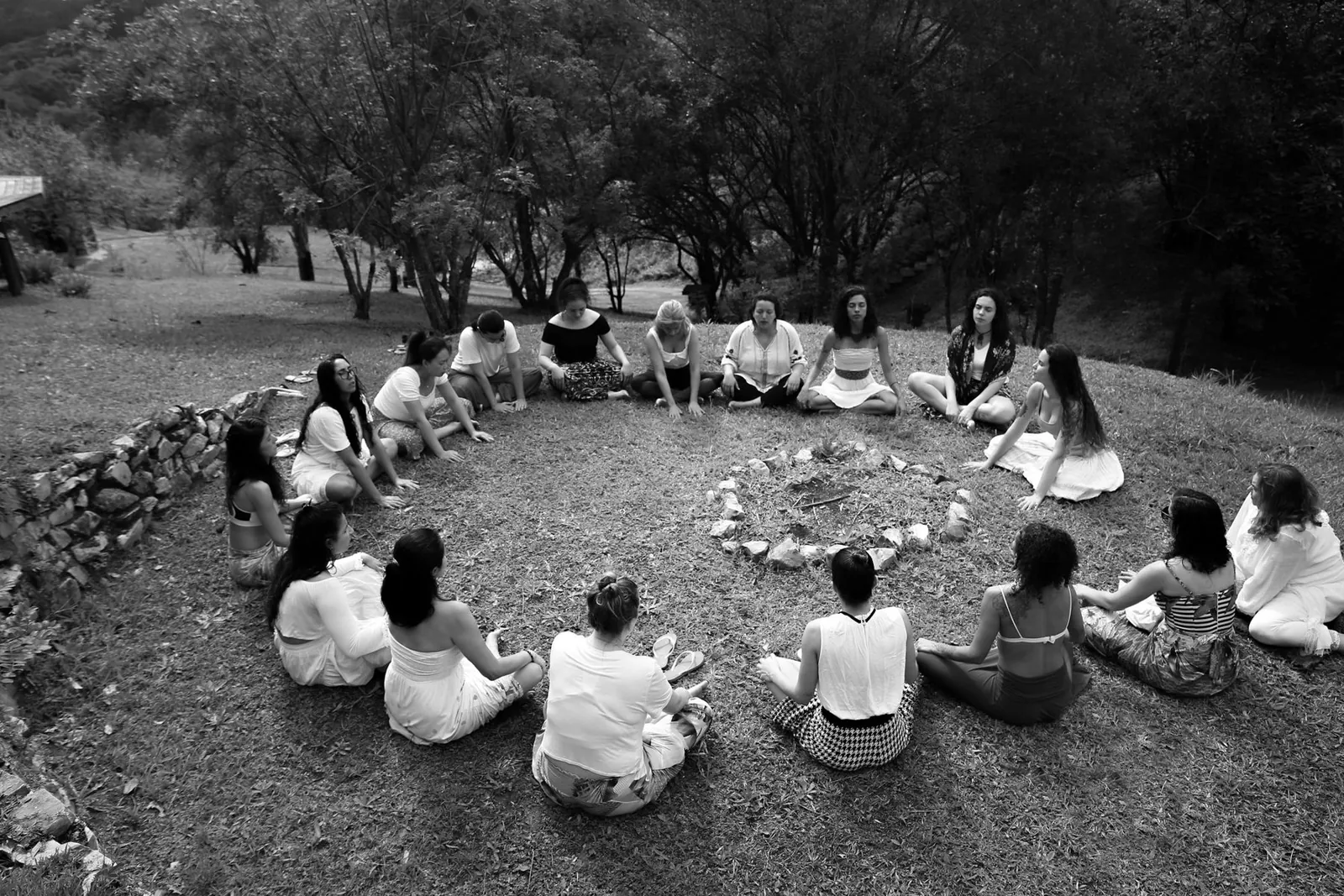A circle of women gathered around a fire